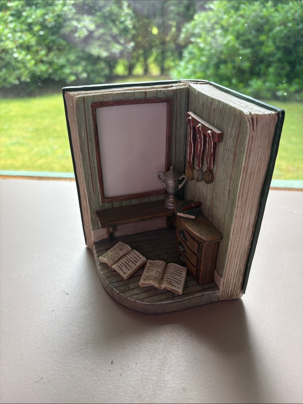 Picture frame decoration with open book and awards